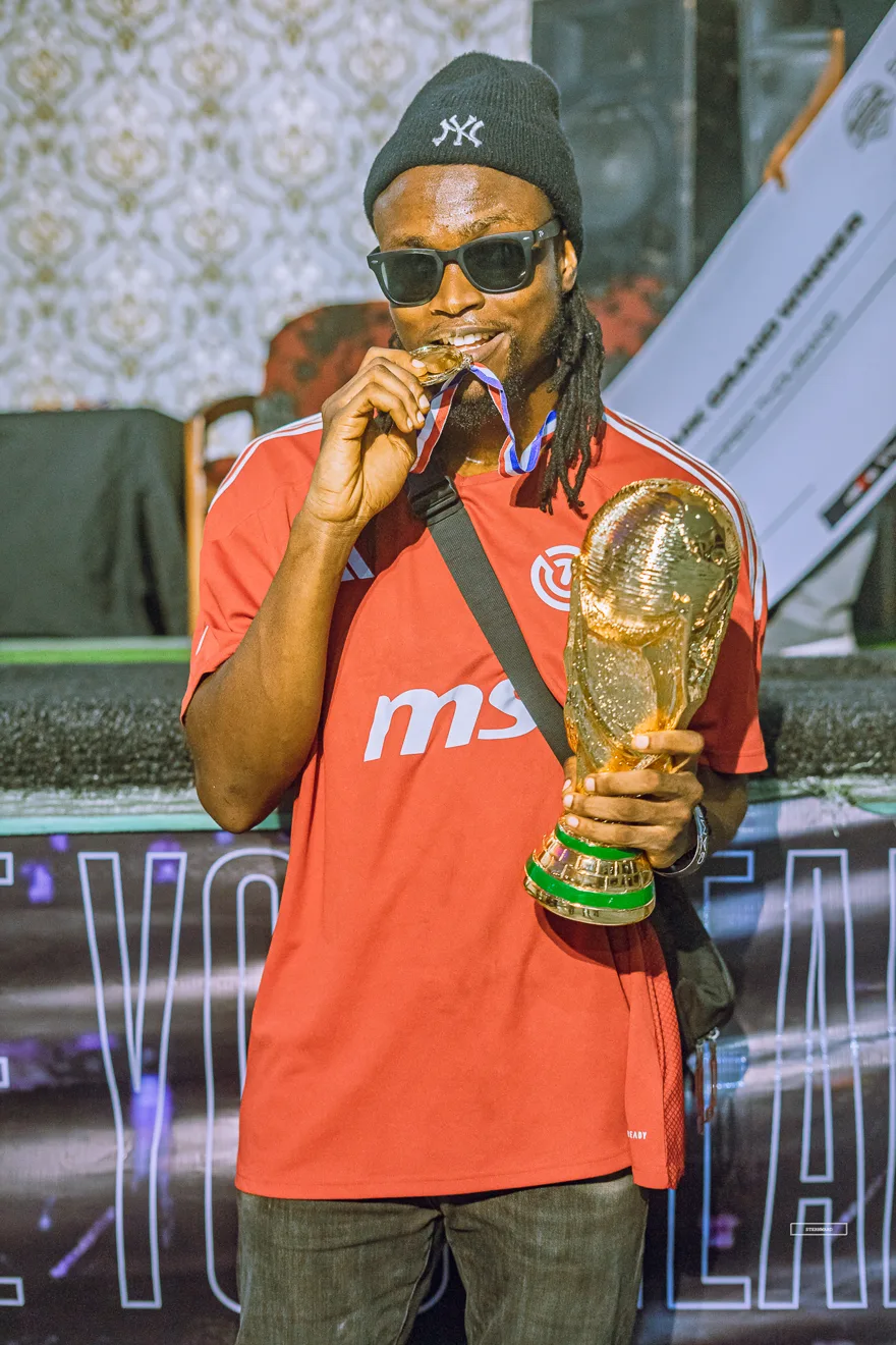 FC26 champion kissing the golden trophy at Invasion 2025
