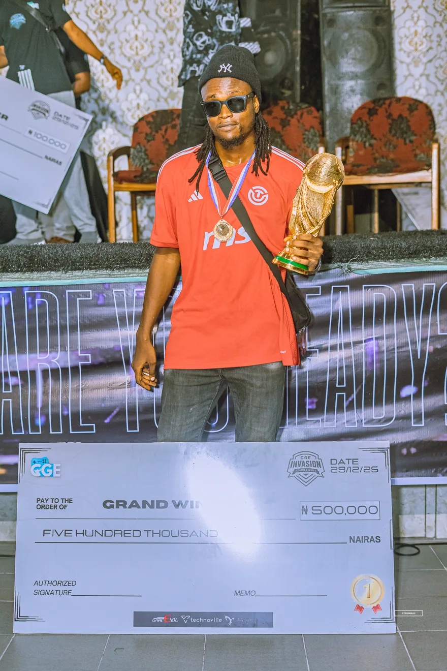 Grand winner holding the five hundred thousand naira cheque and trophy